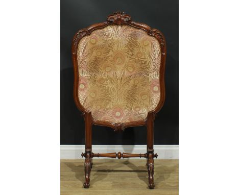 A Victorian walnut fire screen, cartouche shaped frame carved with leaves, the panel worked as peacock feathers, turned stret