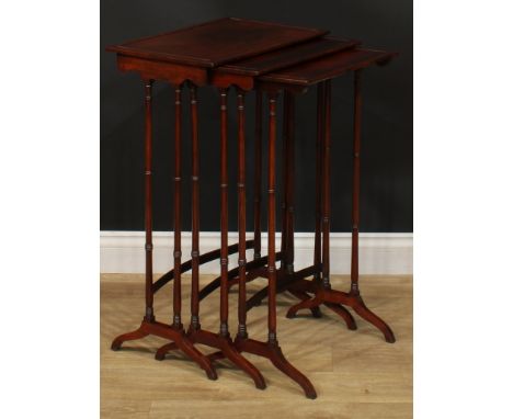 A George III Revival rosewood nest of three occasional tables, each with a rectangular top and ring-turned supports, the larg