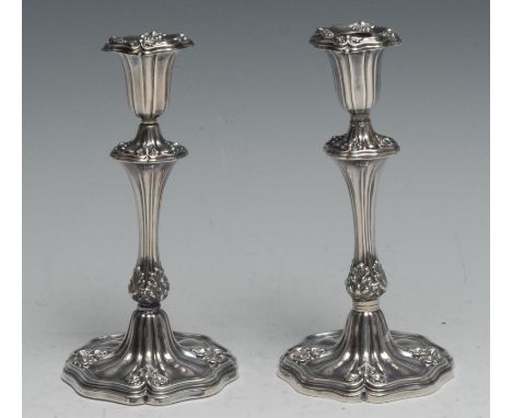 A pair of early Victorian silver tapersticks, fluted and embossed with foliate trefoils, 14.5cm high, Henry Wilkinson &amp; C