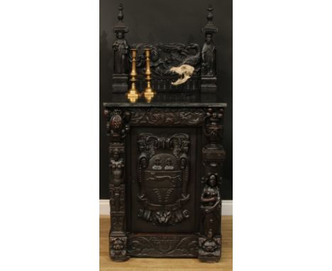 A 19th century historicist oak side cabinet, profusely carved throughout with renaissance and baroque elements, including Sai