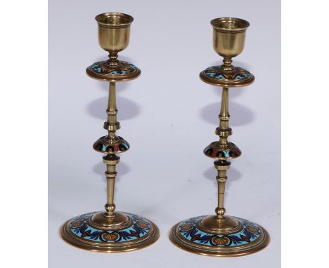 A pair of French champlevé enamel candlesticks, decorated in polychrome on a turquoise ground, 19.5cm high, c.1900 