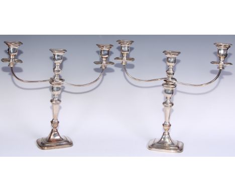 A pair of George III Old Sheffield Plate three-light table candelabra, rectangular campana sconces, pillars and bases, 40cm h