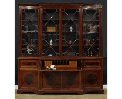 A large Sheraton Revival satinwood banded, fiddleback and flame accented mahogany breakfront secretaire library bookcase, by 