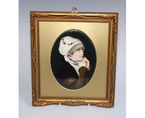 A German porcelain oval plaque, painted with a portrait of a lady, 18.5cm x 14cm, gilt frame, 29cm x 25.5cm overall, early 20