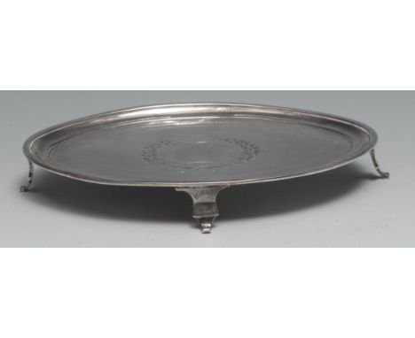 A George III silver oval teapot stand, bright-cut engraved cartouche outlined with wrigglework, 19cm wide, Duncan Urquhart &a