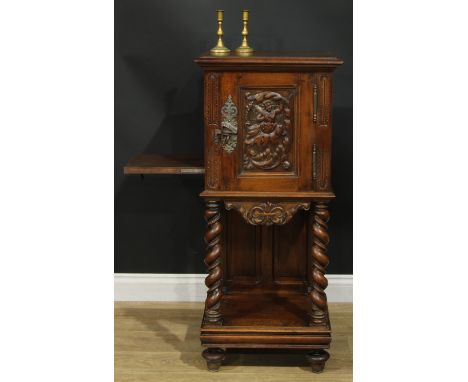 A late 19th century French bedroom night cupboard, rectangular top with moulded edge above a panel door carved and applied wi