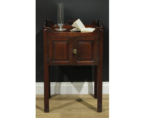 A George III mahogany tray top bedroom night cupboard, shaped and pierced gallery above a pair of raised and fielded panel do
