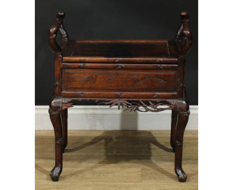A Chinese padouk wood piano stool, hinged panel seat, carry handles to sides, carved and incised with leafy bamboo, cabriole 