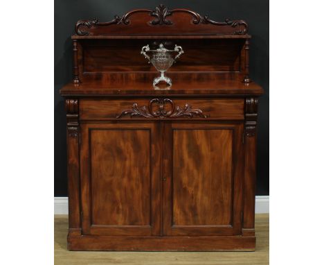 A Victorian mahogany chiffonier, shaped superstructure with shallow shelf, the projecting base with a long frieze drawer abov