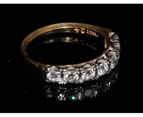 An 18ct gold ring, set with a row of seven brilliant cut diamonds, size M, marked 18ct, 3.1g 