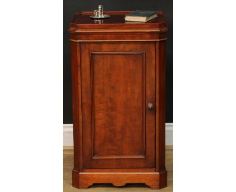 A 19th century mahogany bedroom pedestal, canted rectangular top with moulded edge above a panel door enclosing a shelf, shap