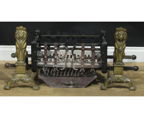 A country house cast iron and brass fire basket, the andirons as standing lions, the grate 46cm x 29cm 