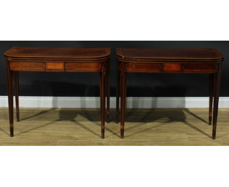 A pair of George III mahogany D-shaped card tables, each with a hinged crossbanded top enclosing a baize lined playing surfac