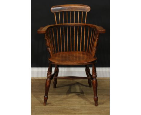 A 19th century ash and elm Windsor elbow chair, low comb back with curved cresting rail, curved arm rail with broad hand rest