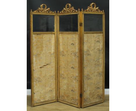 A Louis XVI Revival giltwood and gesso three-fold screen, each bevelled quarter-glazed panel crested by a quiver of arrows cr
