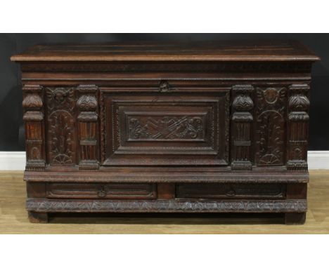 A late 17th/early 18th century Continental oak mule chest, hinged top enclosing a till, the front carved and applied with arc