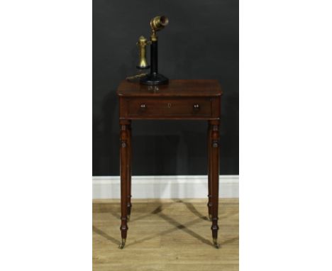 A Regency mahogany work table, rounded rectangular top above a long cockbeaded frieze drawer, ring-turned legs, brass casters