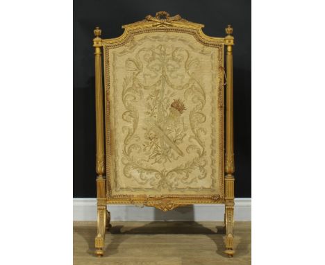 A Louis XVI Revival giltwood fire screen, arched cresting carved with a quiver of arrows crossed with a flambeau and centred 