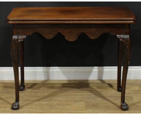 A George II mahogany card table, hinged top enclosing a baize lined playing surface and counter wells, shaped apron, straight