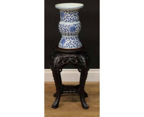 A Chinese hardwood jardiniere stand, circular top with inset marble panel, pierced and carved with lotus and scrolling leaves
