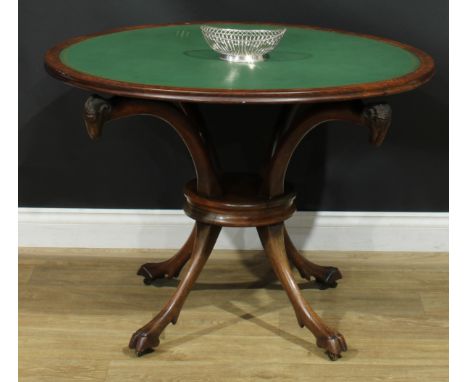 A 19th century rosewood room centre writing or card table, circular top with inset tooled surface, outswept supports terminat