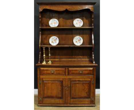 An 18th century style yew crossbanded oak dresser, moulded cornice above two plate racks, the base with a pair of short drawe