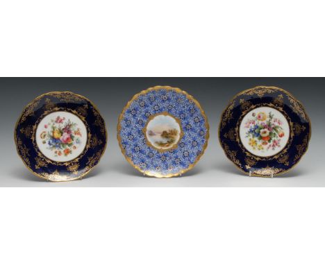 A pair of Coalport  shaped circualr  plates,  painted by  F. Howard, signed with flowers, cobalt blue and gilt rim, 22cm diam