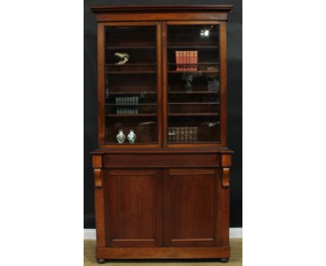 A Victorian mahogany library bookcase, outswept cornice above a pair of glazed doors enclosing four adjustable shelves, the p