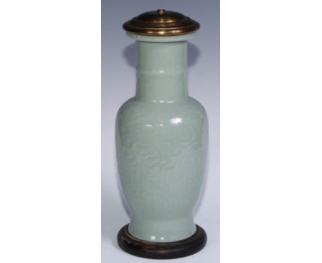 A Chinese celadon ovoid vase, moulded in shallow relief with scrolls, 31.5cm high, later mounted as an electric table lamp, 3