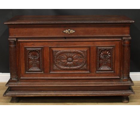 A late 17th/early 18th century Continental oak chest, hinged top above a three panel front, carved with shells and leaves, th