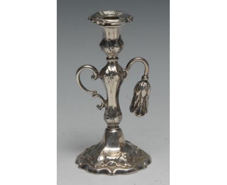 A Victorian silver chamber taper stick, campana sconce with detachble nozzle, scroll handle, embossed throughout with Gothic 