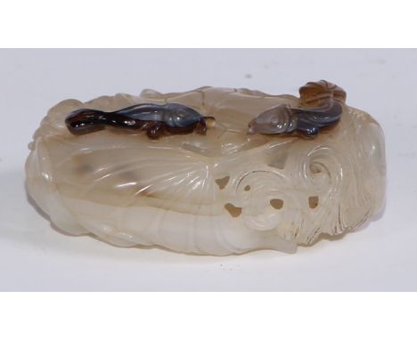 A Chinese pale celadon jade ovoid carved and pierced hollow bead, well carved with stylised water lilies and catfish, 5.5cm l