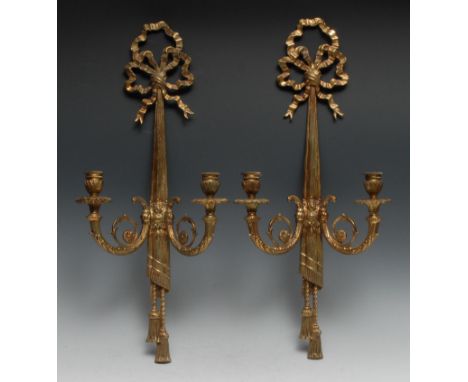 A gilt metal two-light wall lights, ribboned tied, cast with drapes, 60cm high 