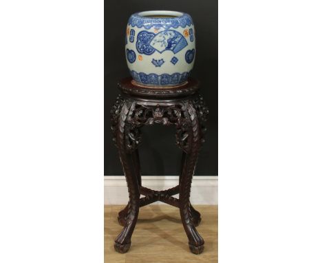 A Chinese hardwood jardiniere stand, circular top with foliate carved edge and inset marble panel, above a shaped and pierced