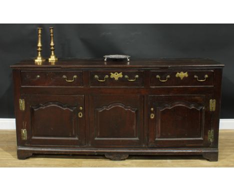 An 18th century oak low dresser, rectangular top above three drawers and three raised and fielded panel doors, 88cm high, 186