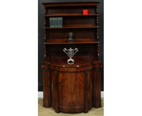 A 19th century flame mahogany library bookcase side cabinet, outswept cornice above three waterfall shelves, the projecting b