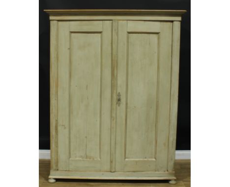 A French Provincial design painted pine armoire, outswept cornice above a pair of panel doors, skirted base, bun forefeet, 18