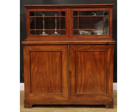 A 19th century mahogany dining room press cabinet, rectangular superstructure with two doors, the projecting base with a pair