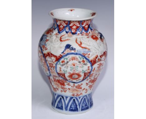 A Japanese ovoid vase, moulded with dragons and painted in the Imari palette, 30cm high, Meiji period 