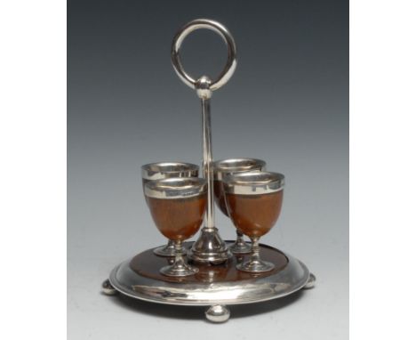 A Victorian silver mounted oak four cup egg cruet, posted ring handle, circular base, bun feet, 24cm high, London 1877 