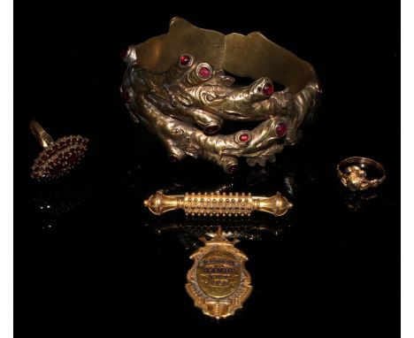 A Victorian hinged bangle, naturalistically formed as oak branches and set with red hardstone cabochons, c.1860; an Etruscan 