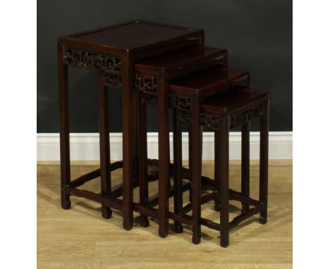 A set of Chinese hardwood quartetto tables, rectangular panel tops, each frieze pierced and carved with clouds, shaped stretc
