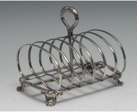 Paul Storr - a William IV silver seven bar toast rack, acanthus-capped handle, kidney shaped divisions, cartouche shaped feet