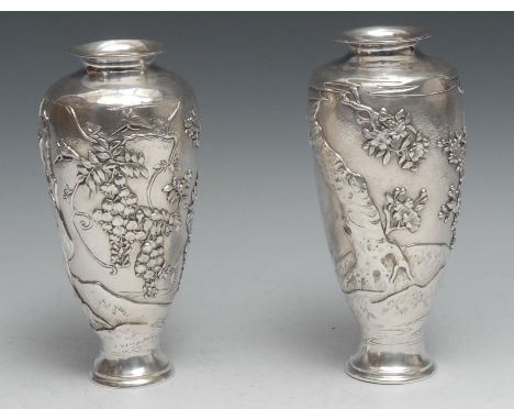 A pair of Japanese silver ovoid vases, chased with birds and blossoming prunus, on a textured ground, 20.5cm high, character 