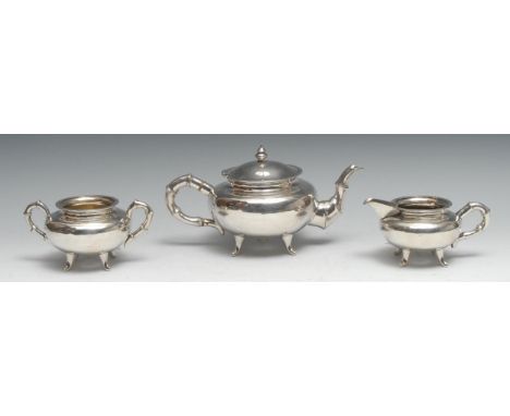 A Chinese silver three piece tea service, comprising teapot, milk jug and sugar basin, faux bamboo spout and handles, the tea