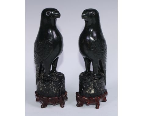 A pair of Chinese jade carvings, of parrots, hardwood stands, 26.5cm high overall, 19th/early 20th century 