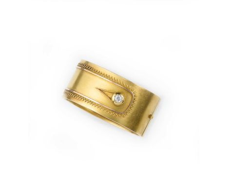 A Victorian gold and diamond bangle, circa 1880, the cuff of hinged design, the front set with a cushion-shaped diamond weigh