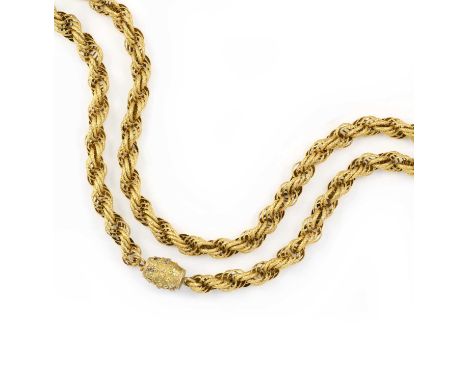 A gold long guard chain, early 19th century, designed as a rope twist chain composed of stamped gold linking, to a barrel cla