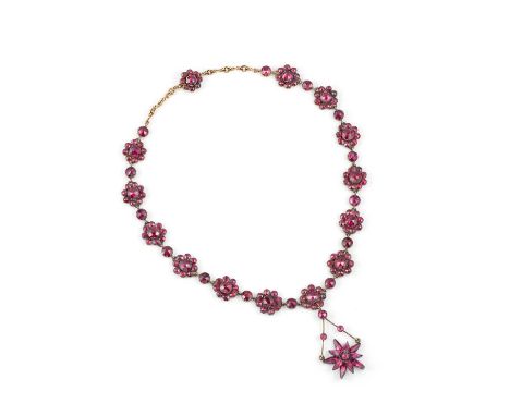 A garnet necklace, possibly southern France, 1830s, composed of clusters of foil-backed rose-cut garnets, suspending a simila