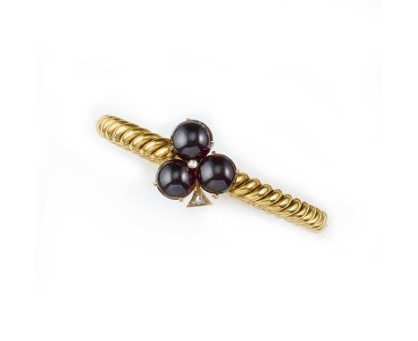 A Victorian gold, garnet and diamond bangle, mid 19th century, centring on a trefoil set with three cabochon garnets, accente